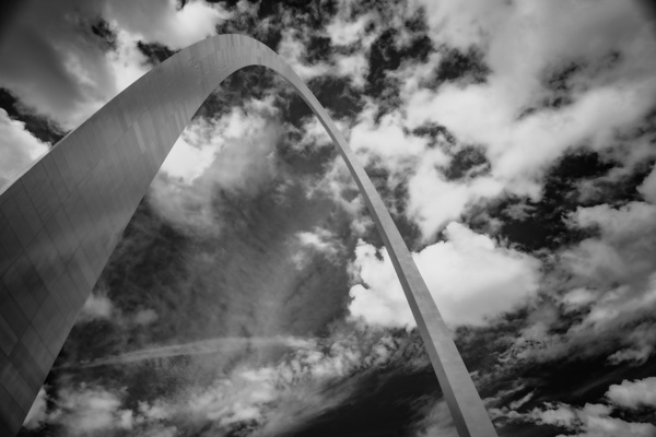 Sculpted Arch Amidst Dynamic Clouds Print
